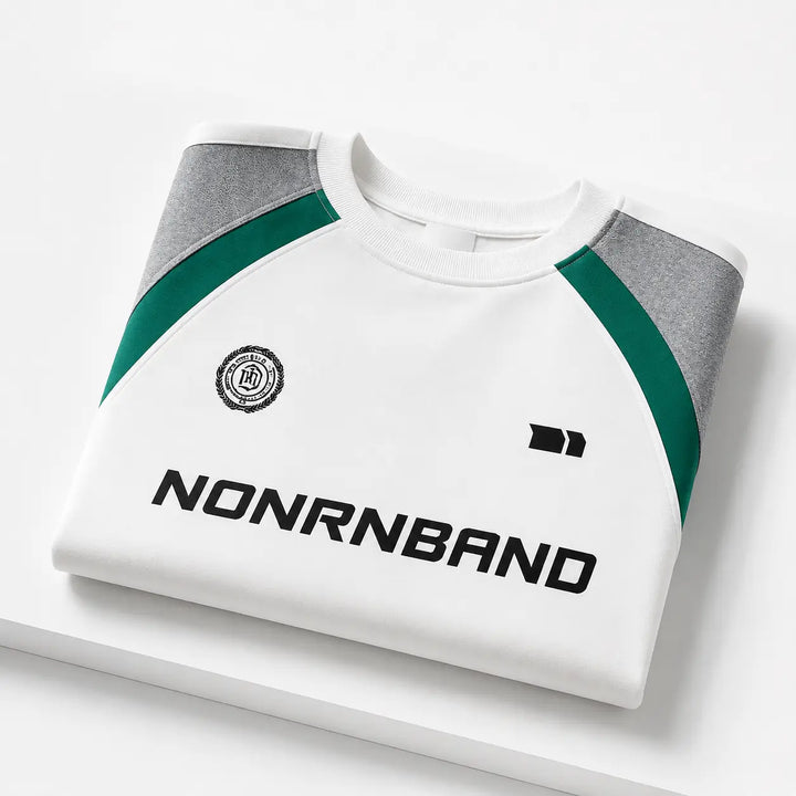 Folded White color block raglan sleeve sweatshirt showing collar, panels and front graphics on white studio plinth.