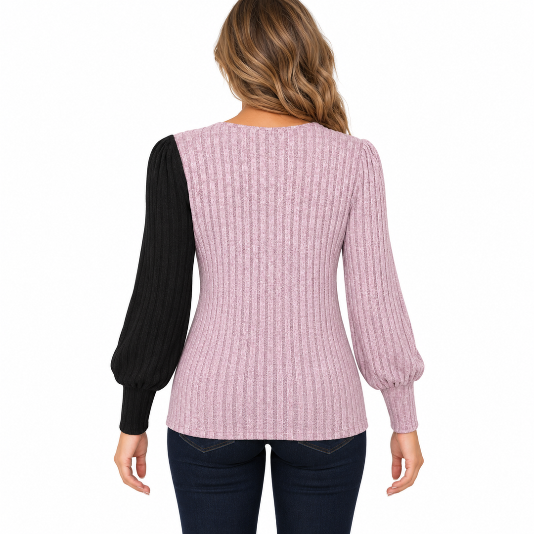 Back view of the pink ribbed knit top with one black sleeve and one pink sleeve