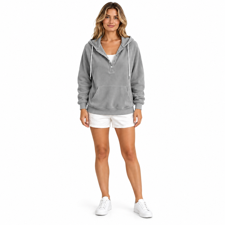 Front view of a woman wearing a grey ribbed hoodie with white drawstrings, button neckline and front pocket on a white scene.