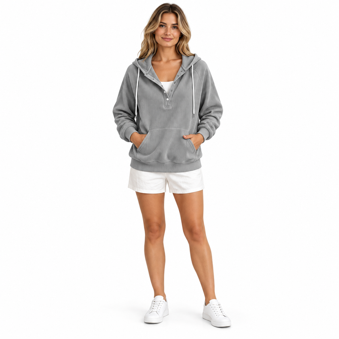 Adult woman wearing a grey corduroy hoodie with snap buttons, white drawstrings and kangaroo pocket, shown in full-body view.