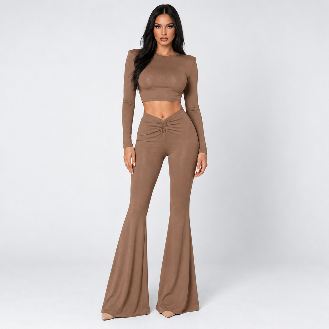 Brown crop top and pants set on model in clean studio front view with long sleeves, ruched waist and flared trousers