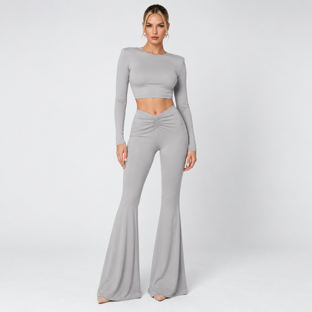 Gray crop top and pants set on model in clean studio front view with ruched V waist and flared trousers