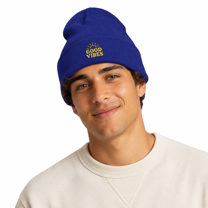 Man wearing royal blue cuffed beanie with embroidered Good Vibes design in a clean professional studio portrait