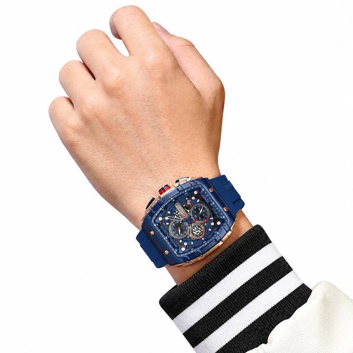 CURREN 8442 watch with navy strap, blue bezel and rose-tone case, worn on an adult wrist