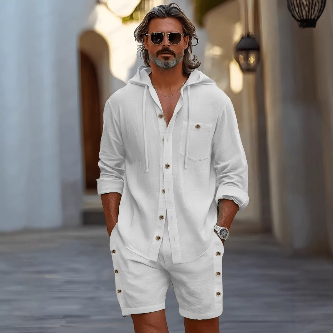 White hoodie and shorts set styled for vacation packing with sneakers and sunglasses