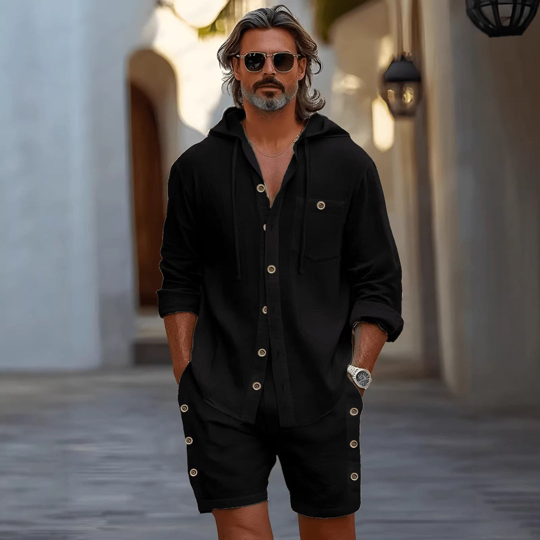 Flat lay of black matching shorts set with folded hooded shirt and drawstring shorts