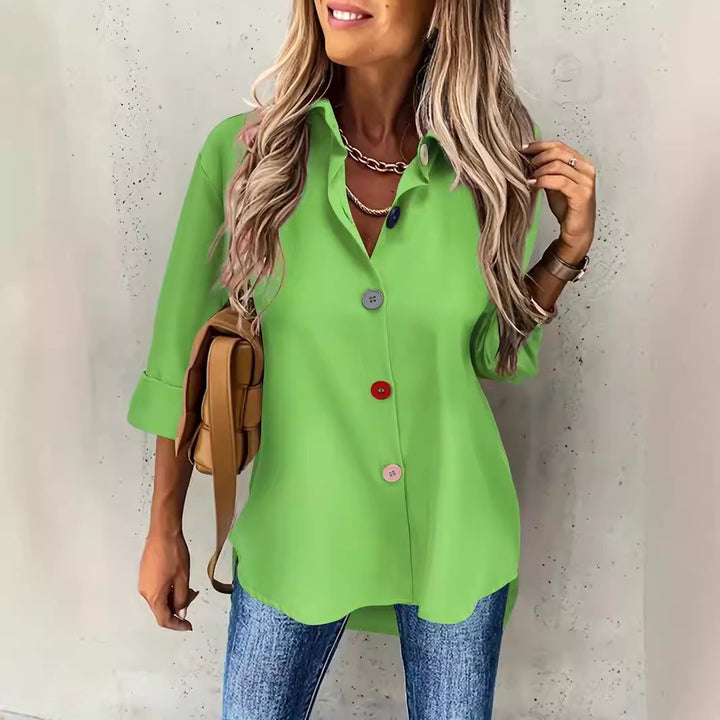 Woman wearing a bright green shirt with a neutral background