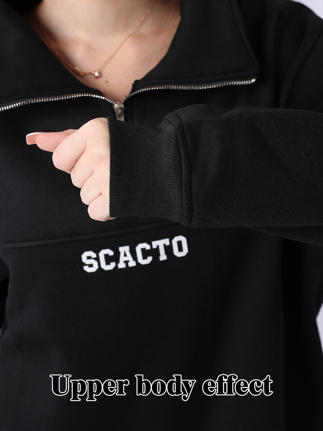 Person wearing a black jacket with &