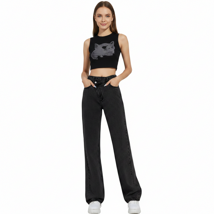 Woman wearing a black sleeveless top with a graphic design and black pants on a white background