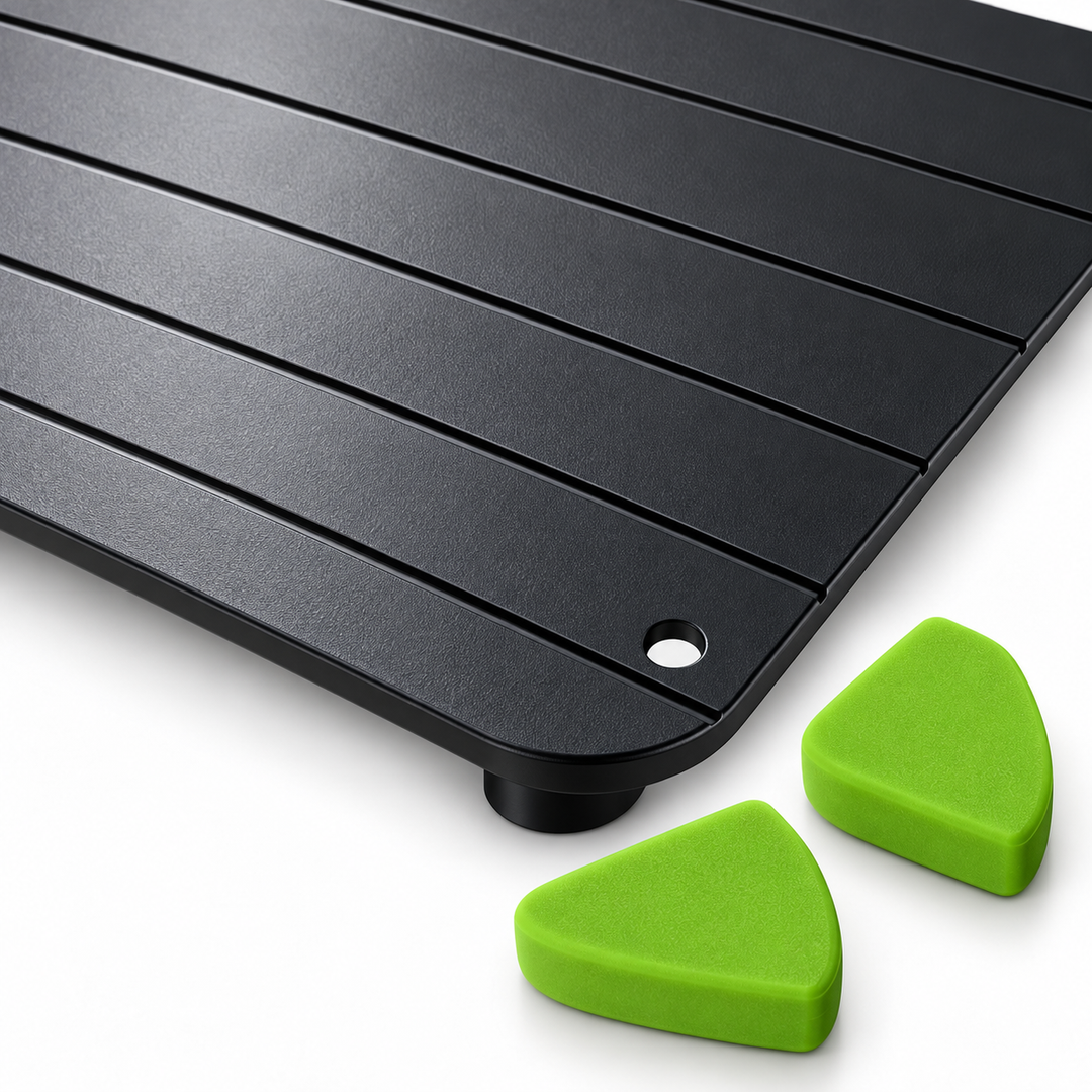Close-up of black ridged tray surface with green corner pieces