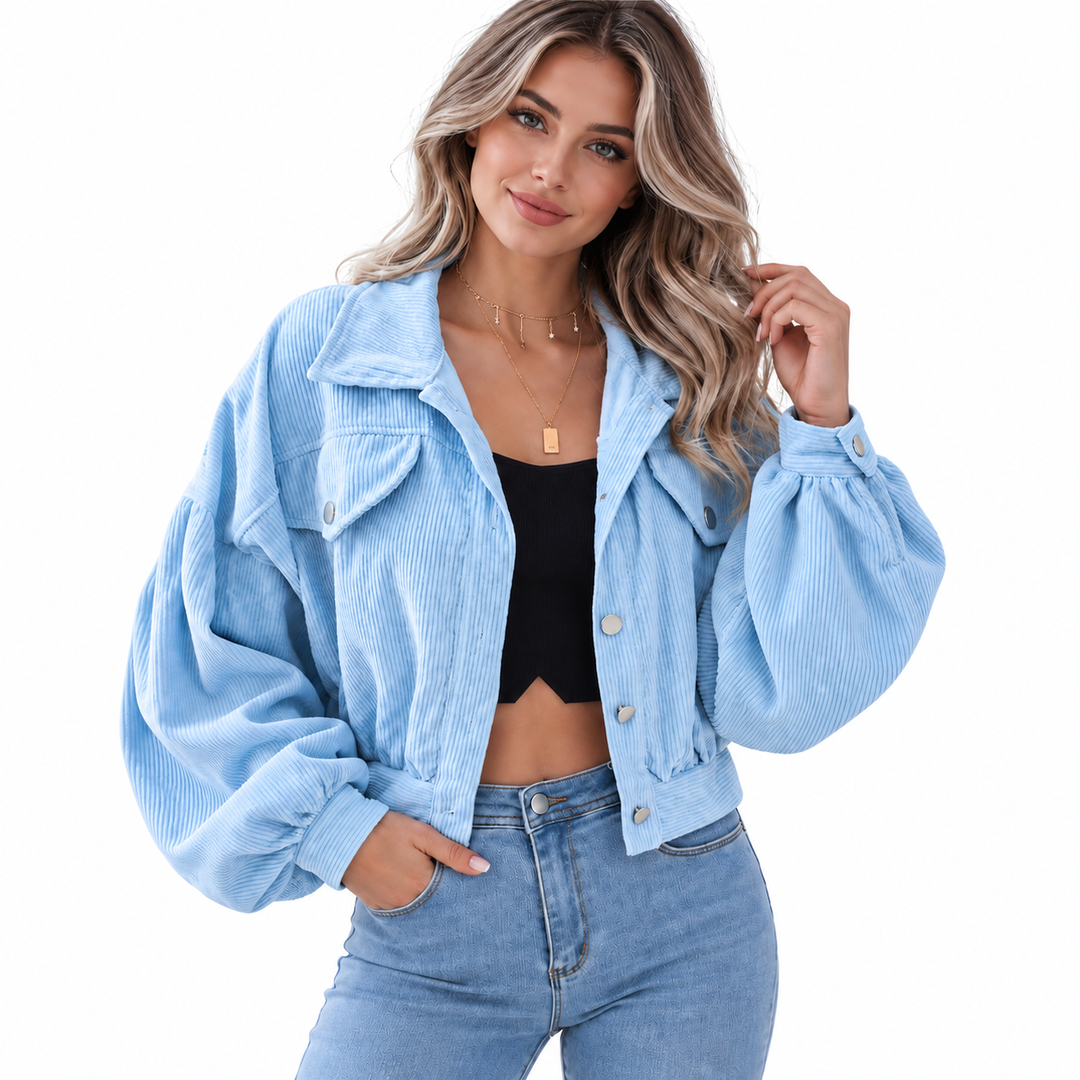 Denim Blue corduroy jacket worn by a model, showing the front construction, collar and gathered sleeves against a white background.