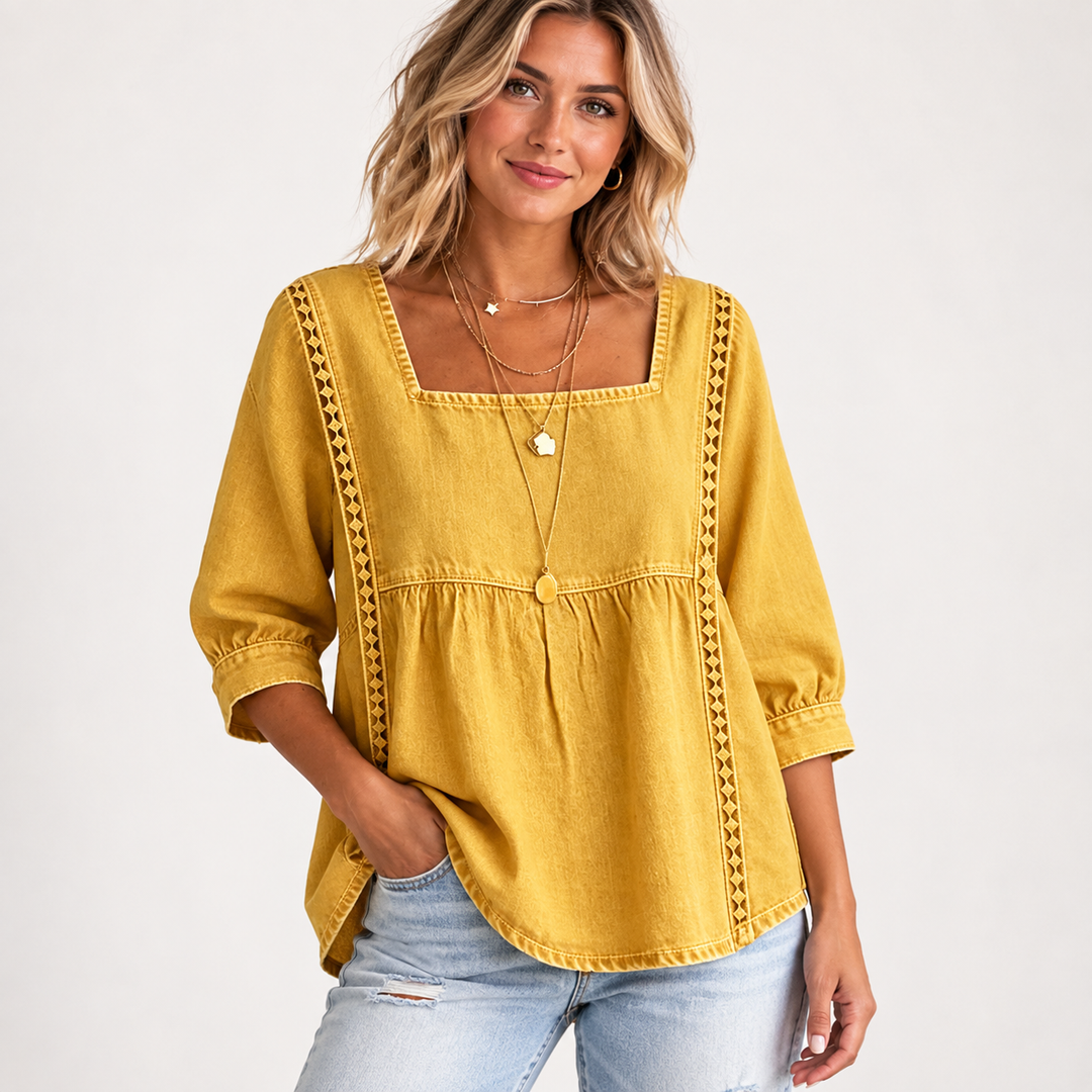 Yellow lace patchwork blouse on a model with square neckline, gathered seam, regular sleeves and casual denim styling.