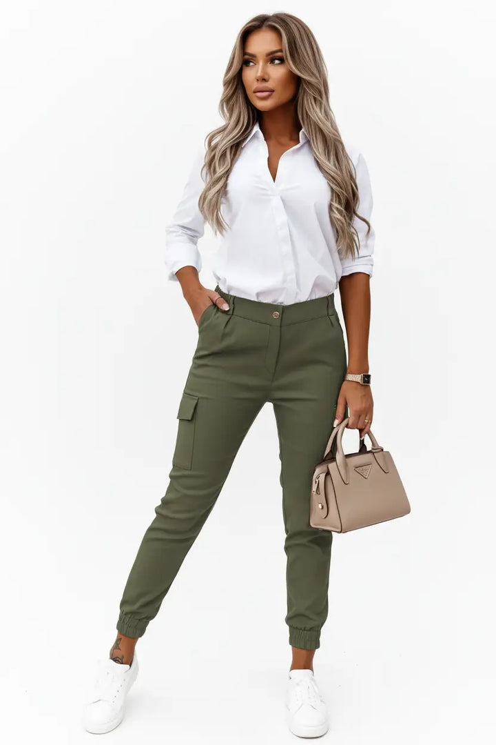 women's cropped trousers black worn with neutral blouse on model seated showing comfortable drape cropped length and relaxed yet polished silhouette suitable for all day refined casual wear