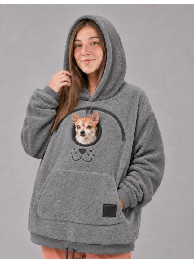 Original image: Woman wearing a gray hoodie with a small dog in the chest opening pictured with the footwear details visible.