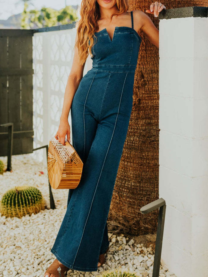 Denim wide leg jumpsuit women rear silhouette view fluid relaxed drape natural movement warm season casual styling