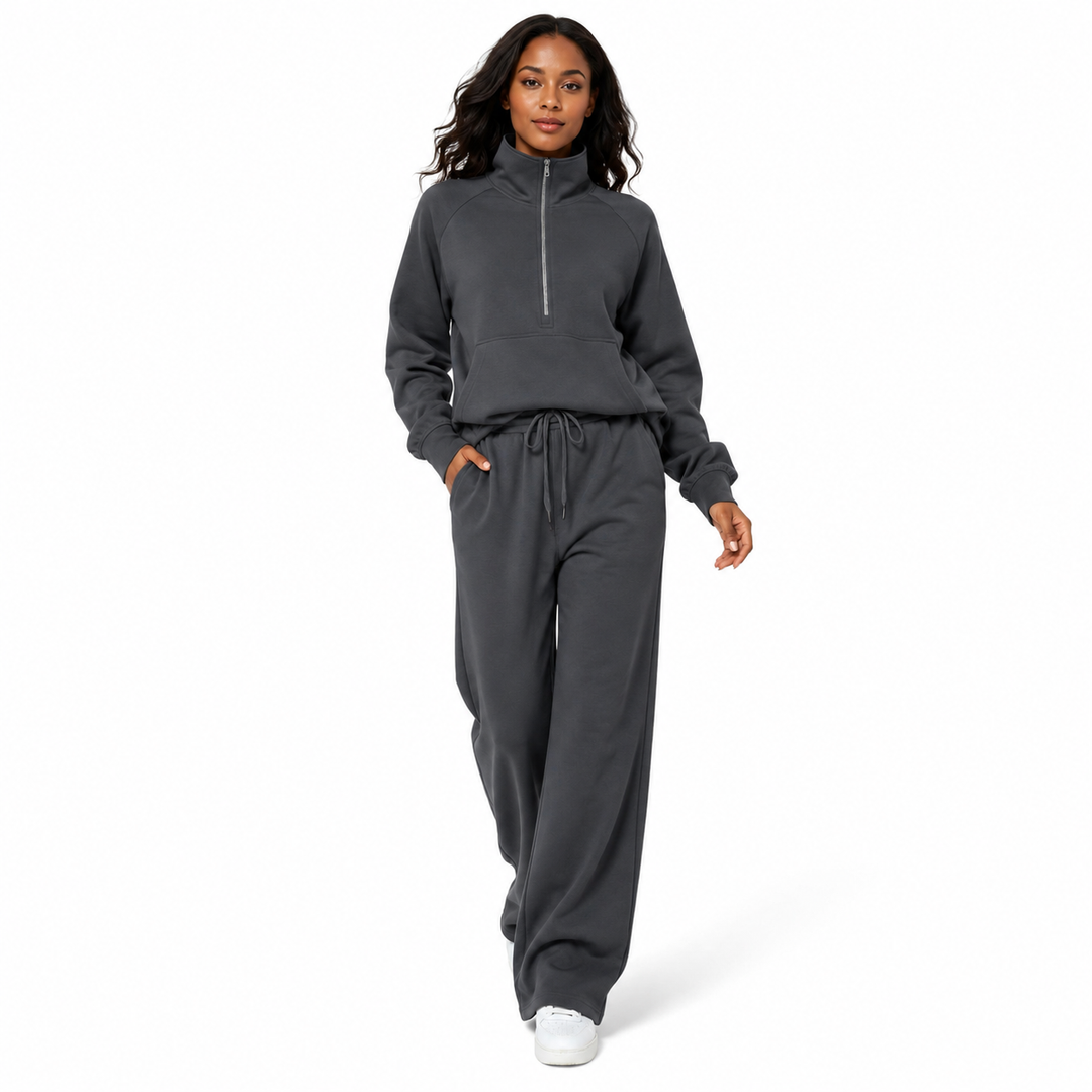 Minimalist tracksuit for women with clean lines, half zip top and wide leg sweatpants in a relaxed coordinated everyday look.