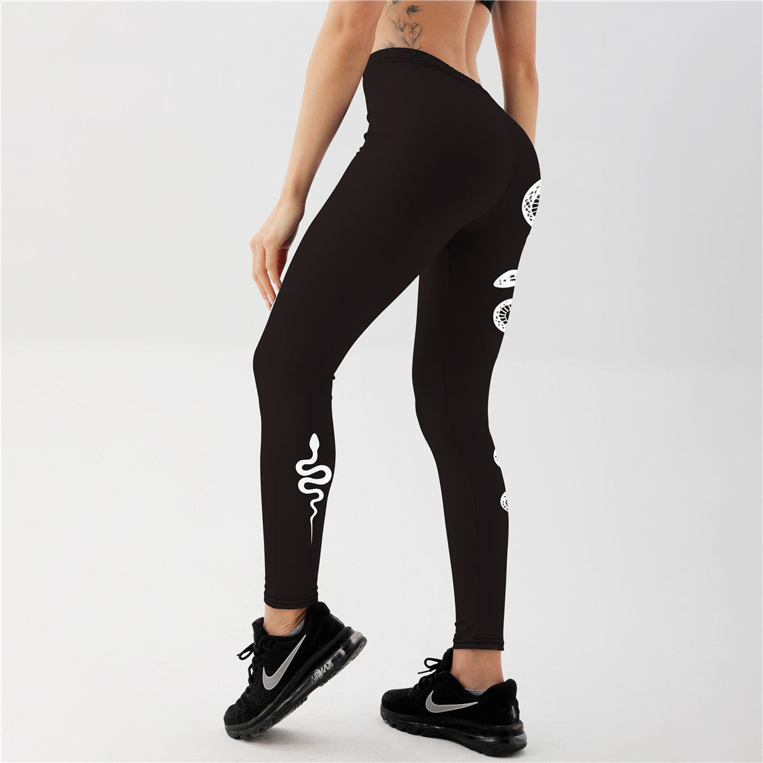 "Women’s black snake print workout leggings with mystical moon detail, sleek nine point length for daily athleisure"