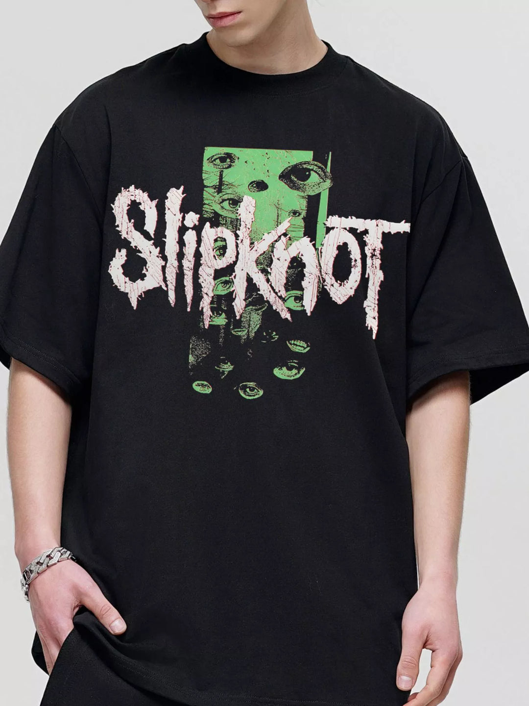 oversized band T-shirt drape across shoulders showing loose modern proportion