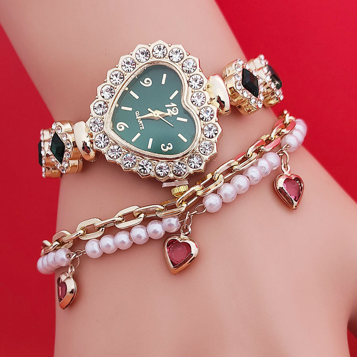 Valentine’s Day heart watch gift set showing gold heart bracelet watch, pearl chain and red heart charms styled together