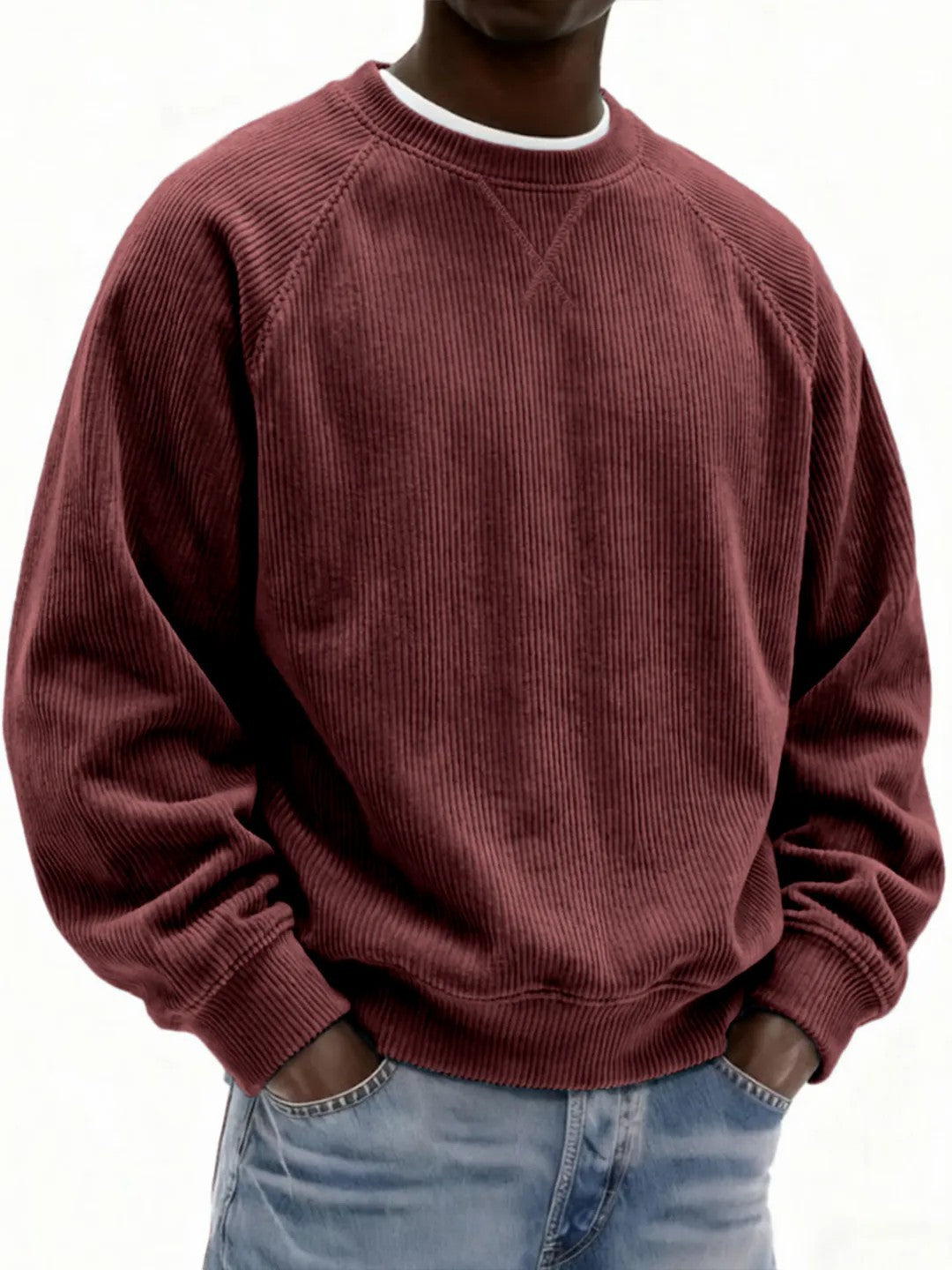 Maroon corduroy sweatshirt worn by a person on a white background