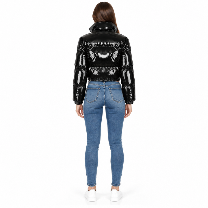 Back view of a black cropped jacket showing horizontal padded panels, long sleeves and gathered cuffs.