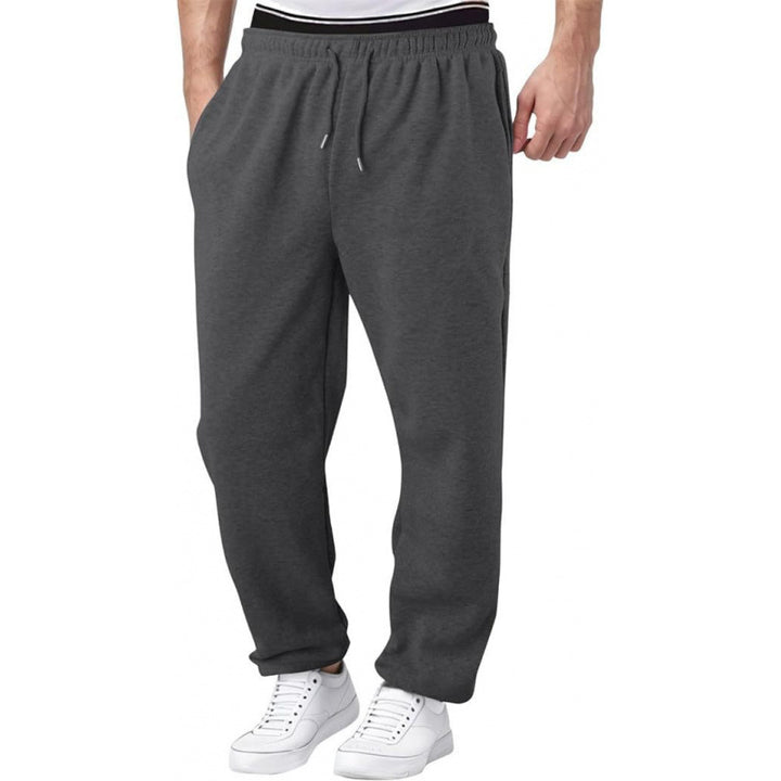 mens sweatpants thick spliced design in dark gray for cool weather layering with trench coats and puffer jackets  
