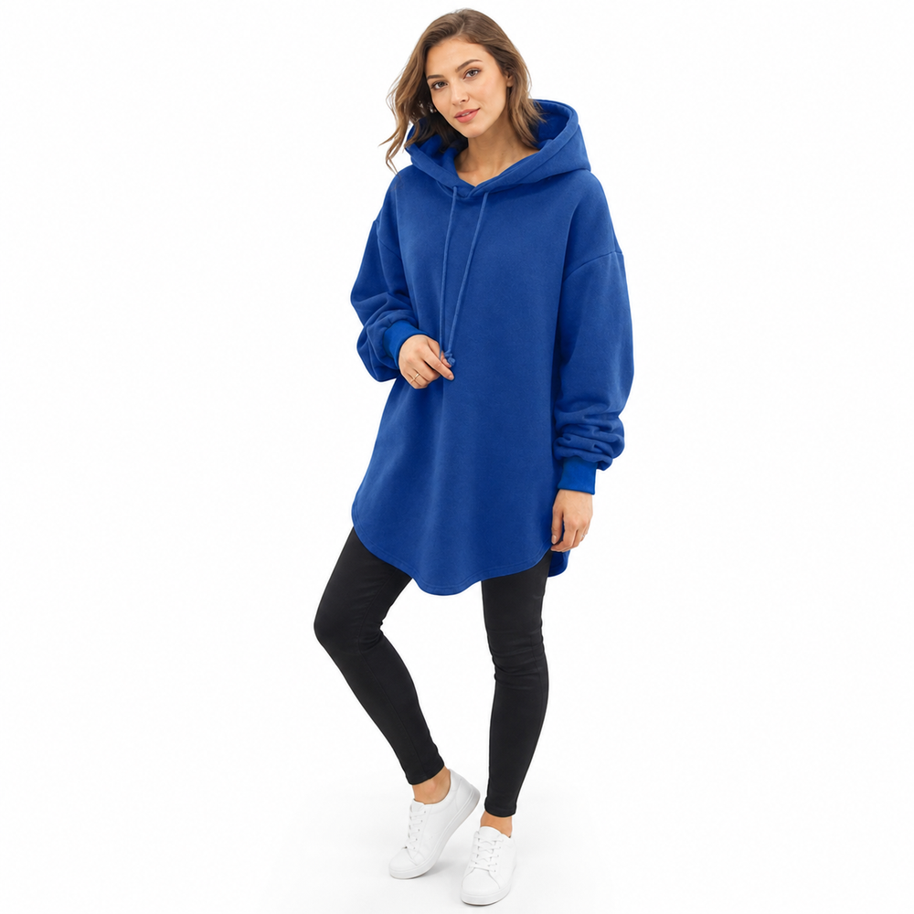 Woman wearing oversized hooded sweatshirt in a clean studio front view