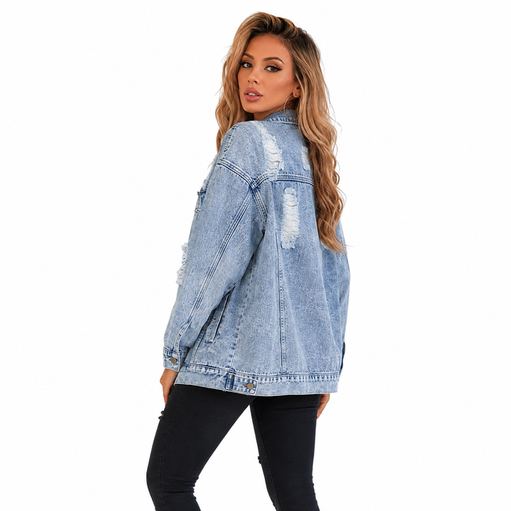 Light blue distressed denim jacket back view showing loose fit, long sleeves and worn detailing