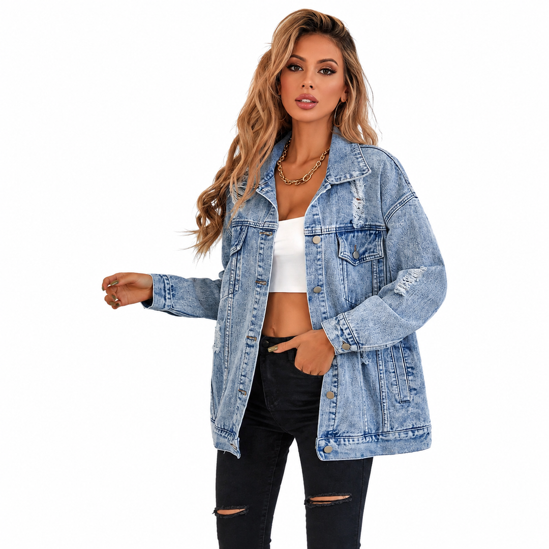Fashionable denim jacket in light blue with distressed details and loose fit on female model
