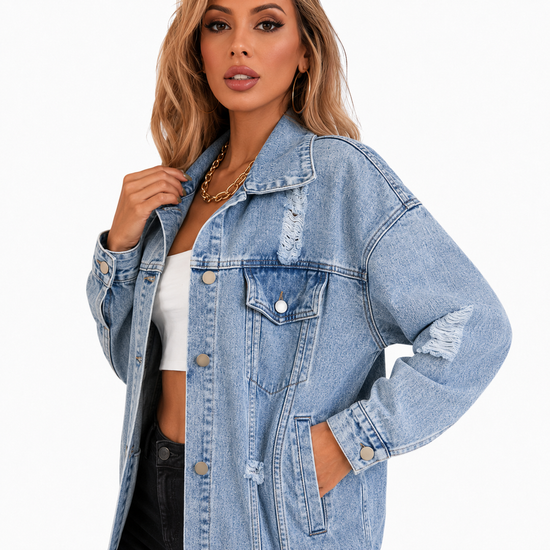 Light blue denim jacket close view highlighting sleeve distressing, cuff, stitching and side pocket