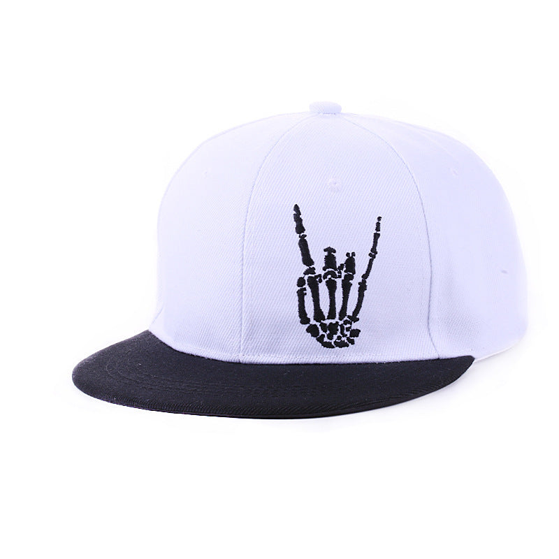 White flat brim hip hop cap flat lay on concrete surface with urban streetwear accessories
