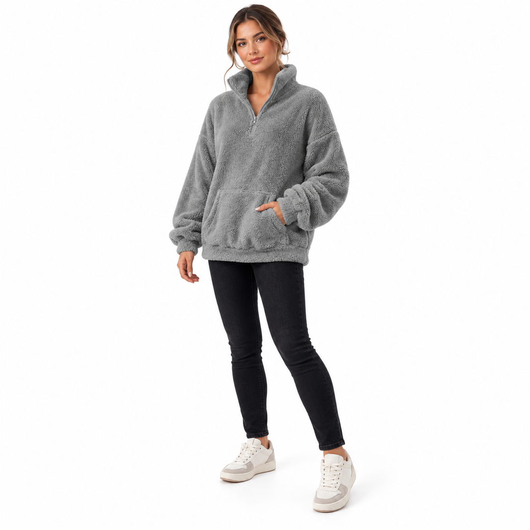 Grey fleece pullover on an adult in a slight three-quarter pose, showing the collar, kangaroo pocket, cuffs and matching hem.