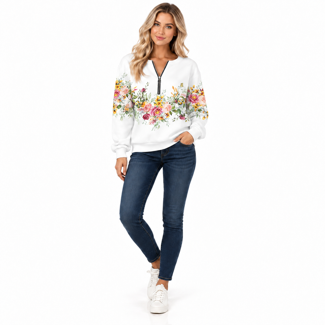 White floral sweatshirt styled with jeans, angled model view