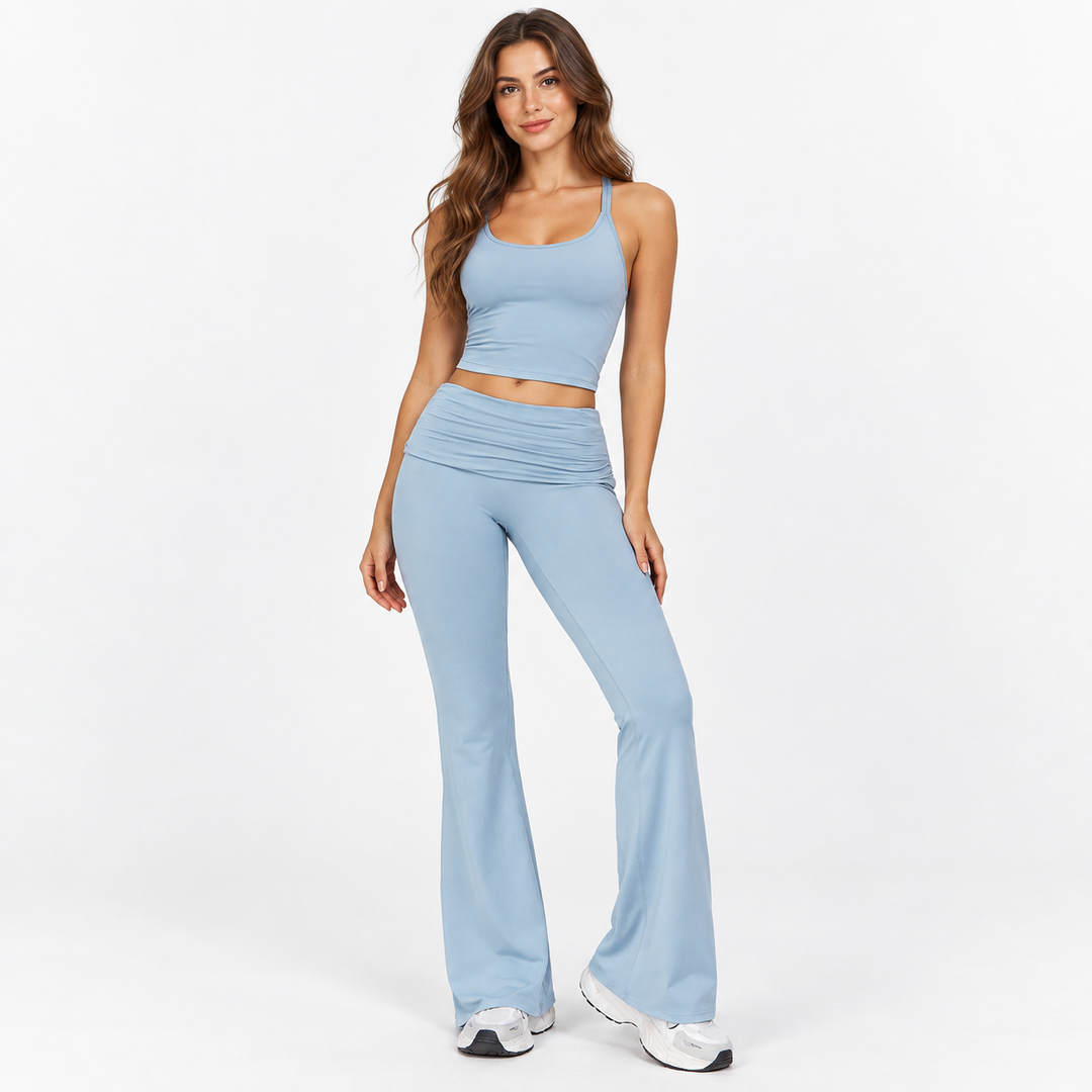 Fold over yoga pants in Haze Blue on full-body model with flared legs and fold-over waistband