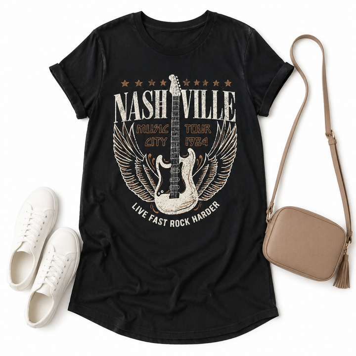 Black Nashville graphic tee dress flat lay styled with white sneakers and a neutral crossbody bag.