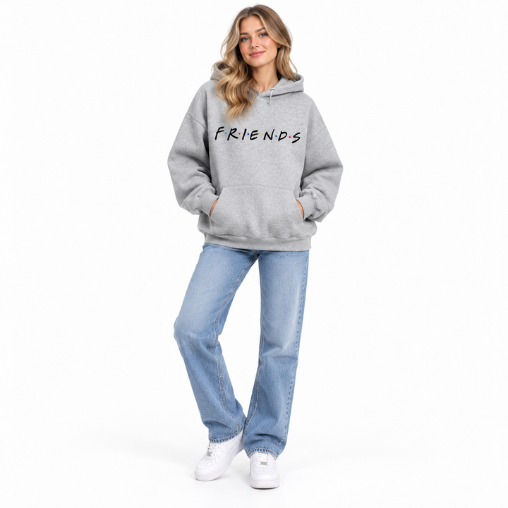 Full-body female model wearing gray letter-print hooded pullover with jeans and white shoes