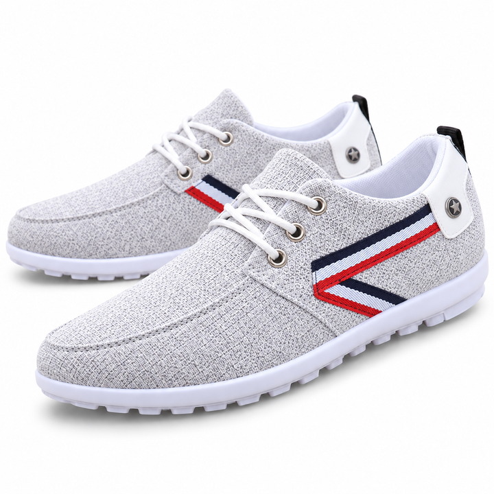 Gray lace-up shoe with tricolor chevron side stripes and white outsole