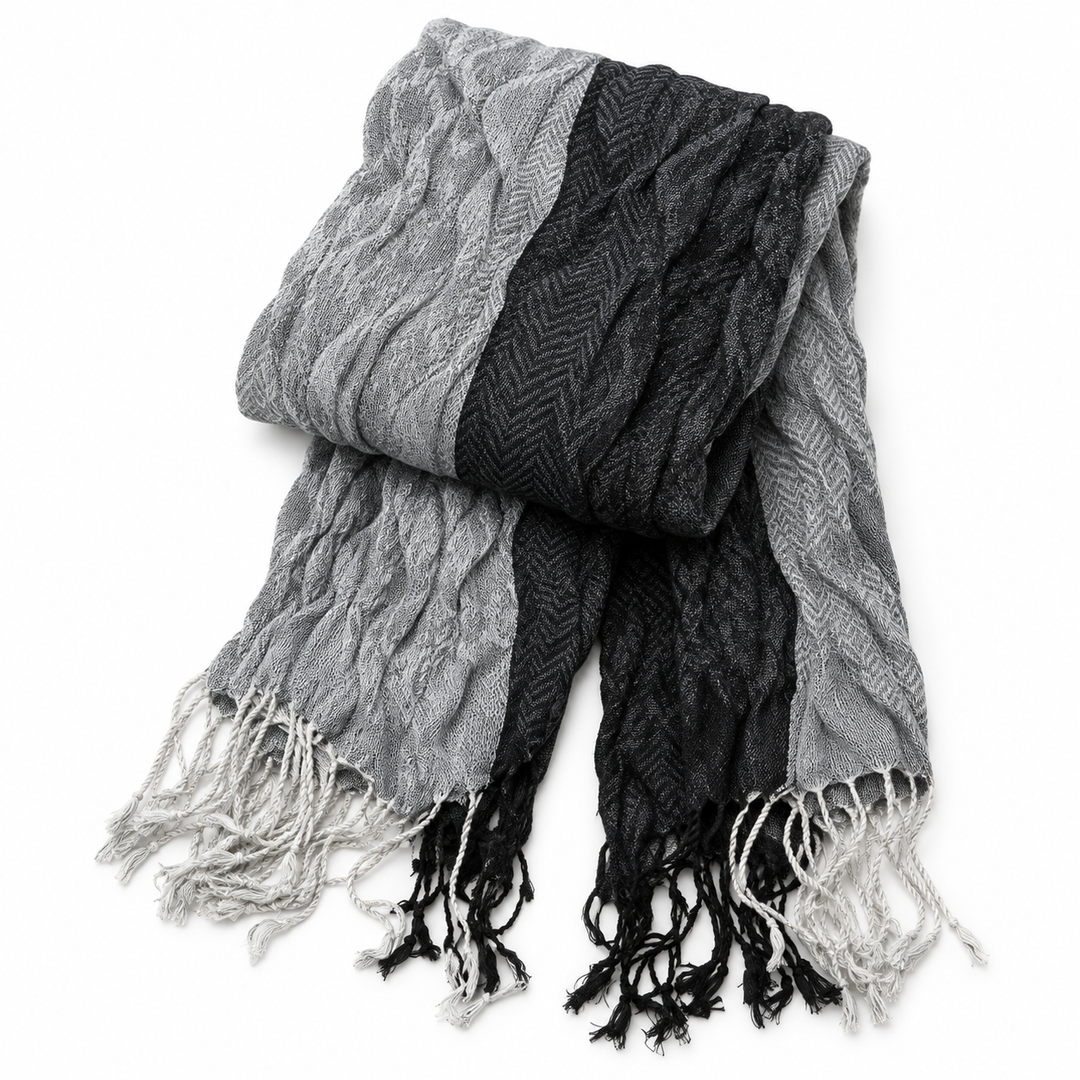 Jacquard scarf folded to show its woven panels, texture and fringed ends.