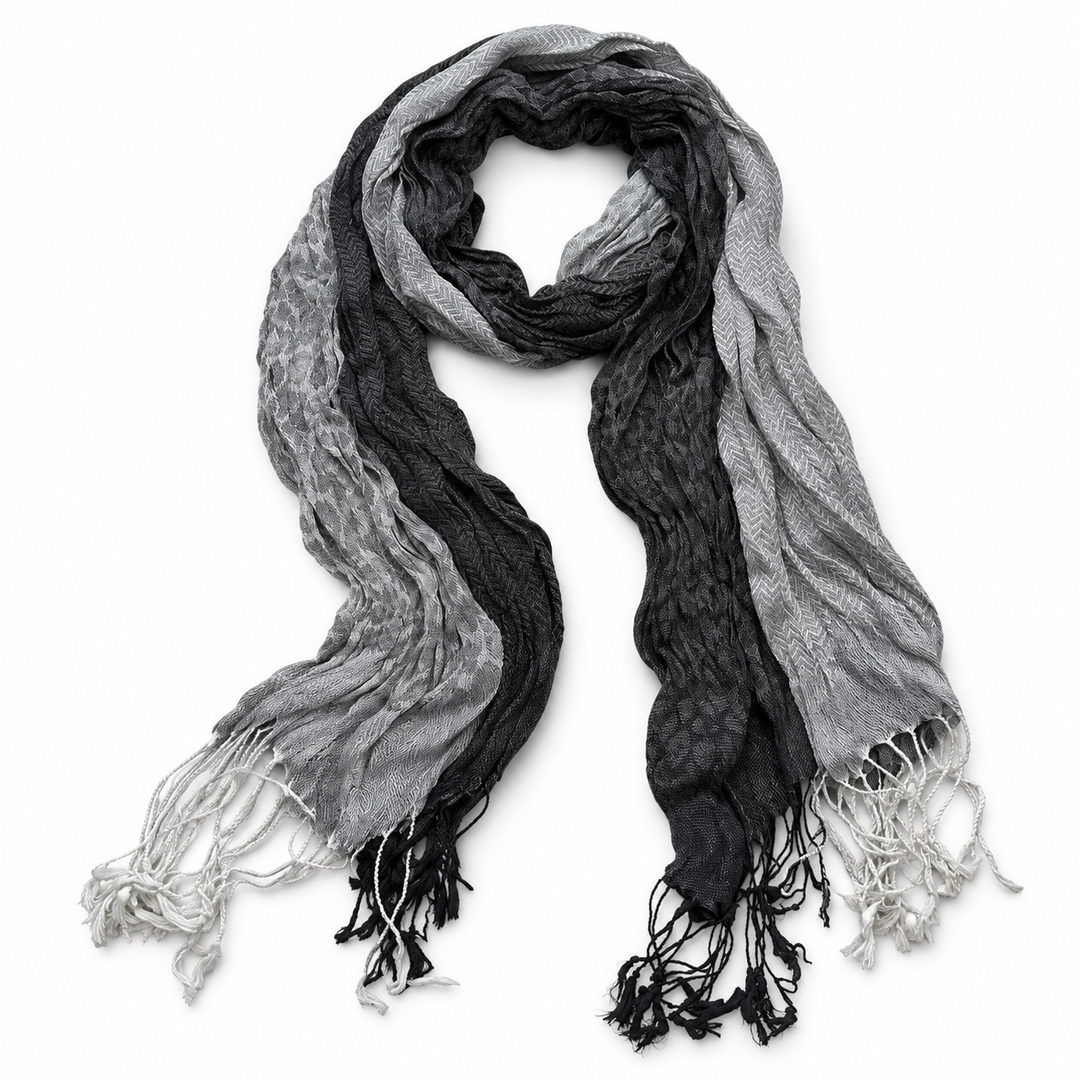 Grey scarf in a long grey-and-black jacquard pattern with fringed ends on white.