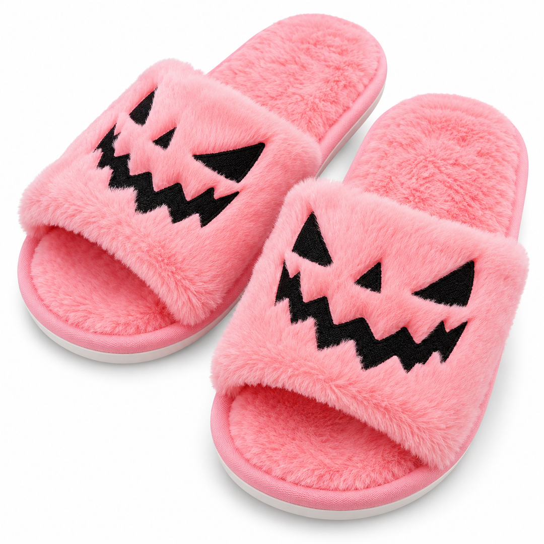 Pink plush Halloween slippers worn indoors, front view