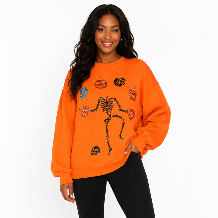 Halloween Skeleton Pumpkin women’s sweatshirt in bright orange with sequin skeleton and pumpkin design - hero front view