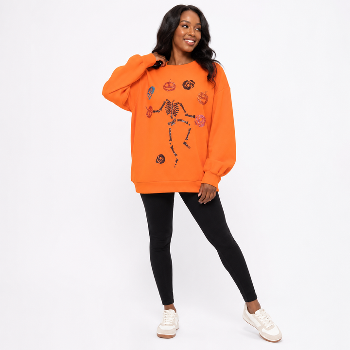 Halloween Skeleton Pumpkin sweatshirt showing relaxed oversized fit and festive sequin front design