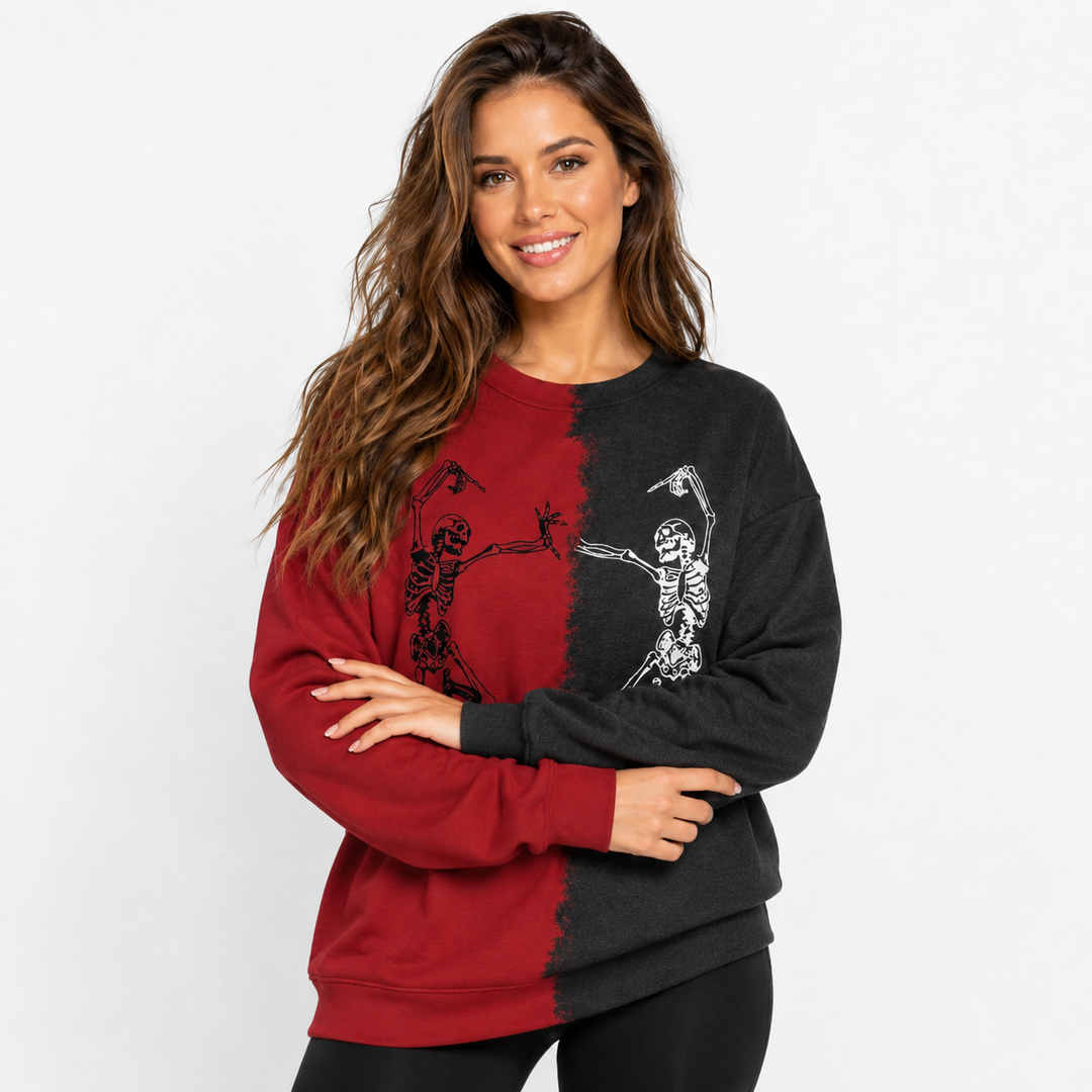 Woman wearing red and black Halloween skeleton sweatshirt with crossed arms in a clean white studio product portrait.