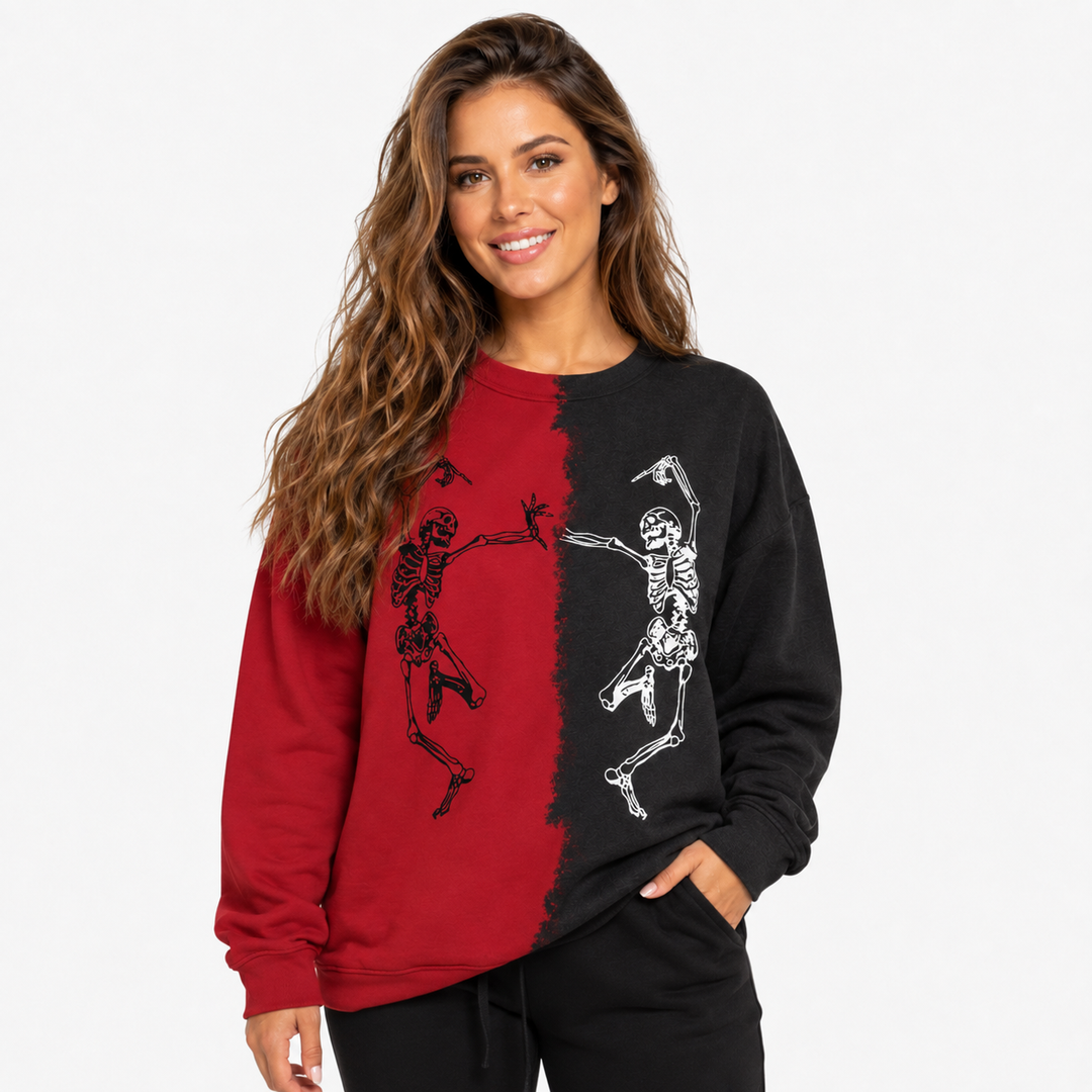 Woman wearing red and black Halloween skeleton sweatshirt with skeleton graphics in a polished waist-up studio view.