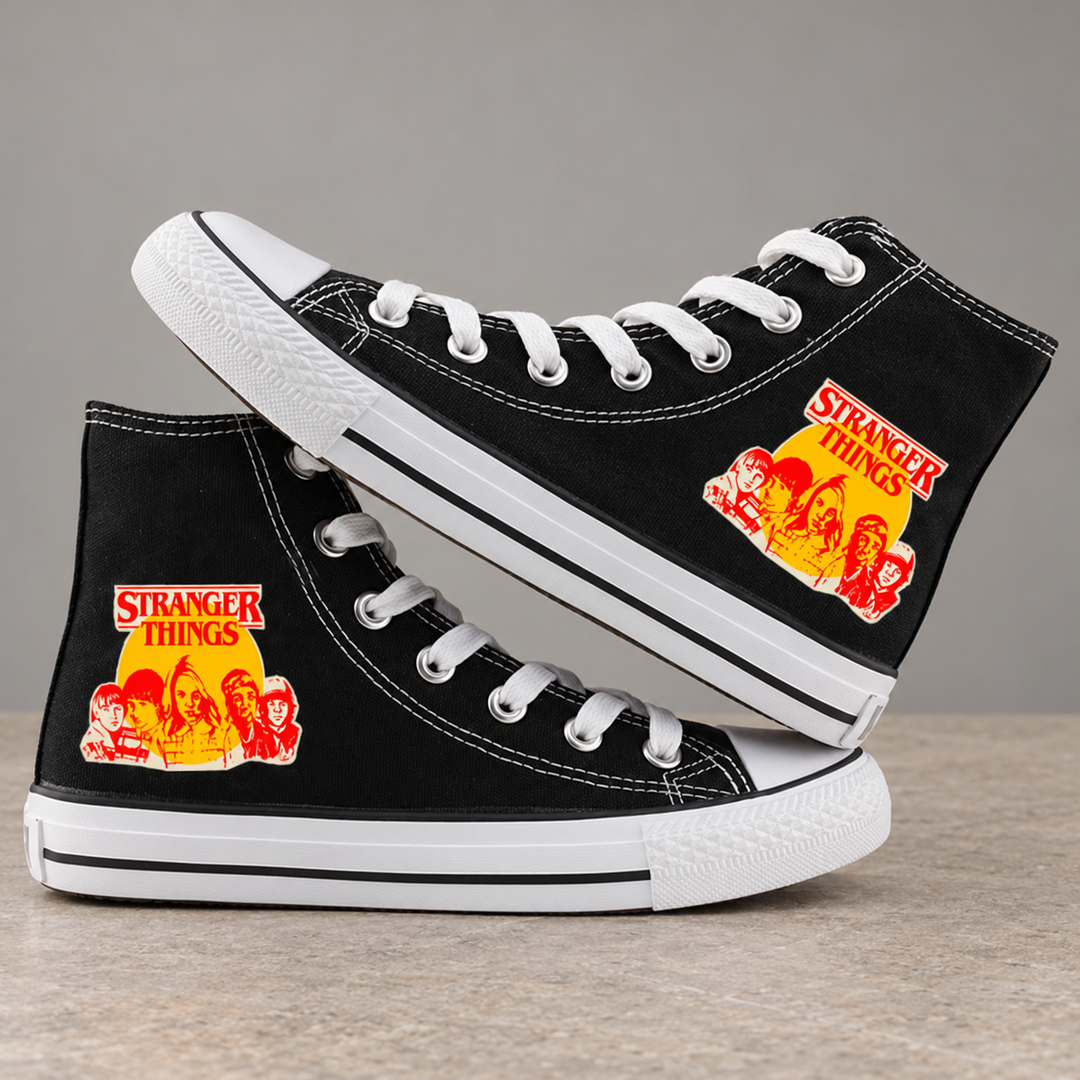Black high-top sneakers, design 1, with the original side graphic on a warm gray studio background