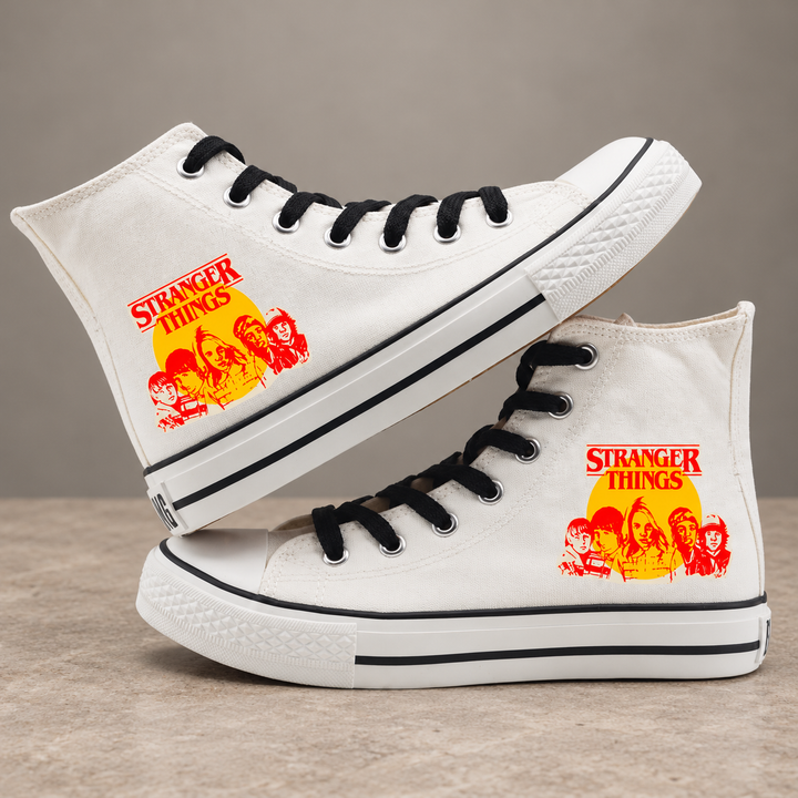 White high-top sneakers, design 1, with the original side graphic on a warm gray studio background