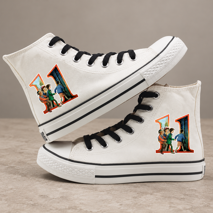 White high-top sneakers, design 2, with the original side graphic on a warm gray studio background