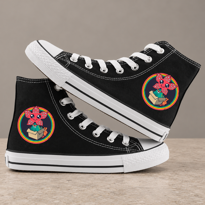 Black high-top sneakers, design 5, with the original side graphic on a warm gray studio background