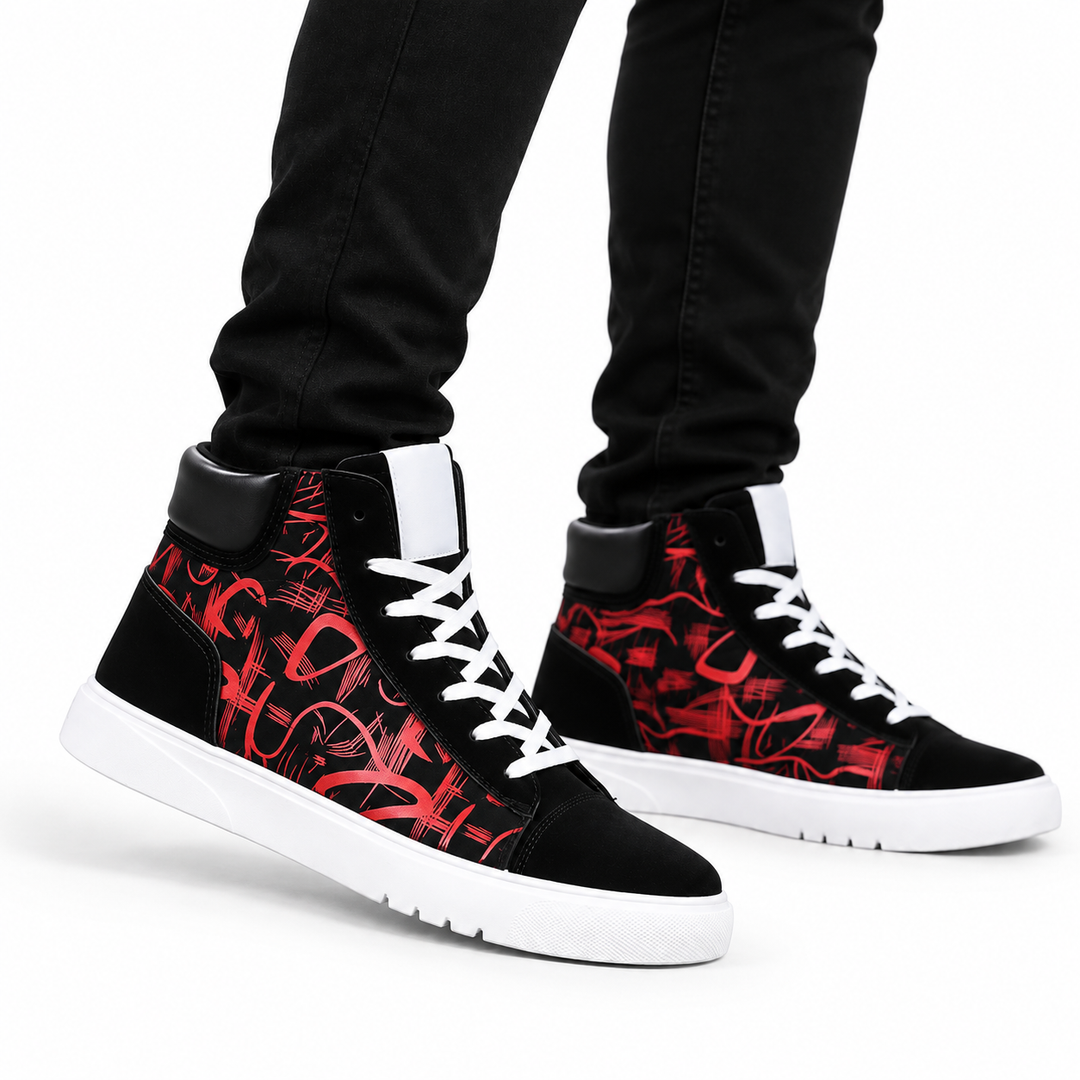 Red graphic high top sneakers worn by a male model with black pants on a white background