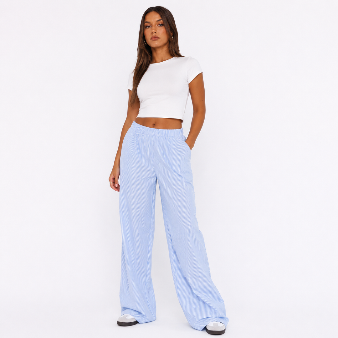 High waisted striped wide leg pants for women in blue stripes on a studio model, showing elastic waist and relaxed Y2K drape.